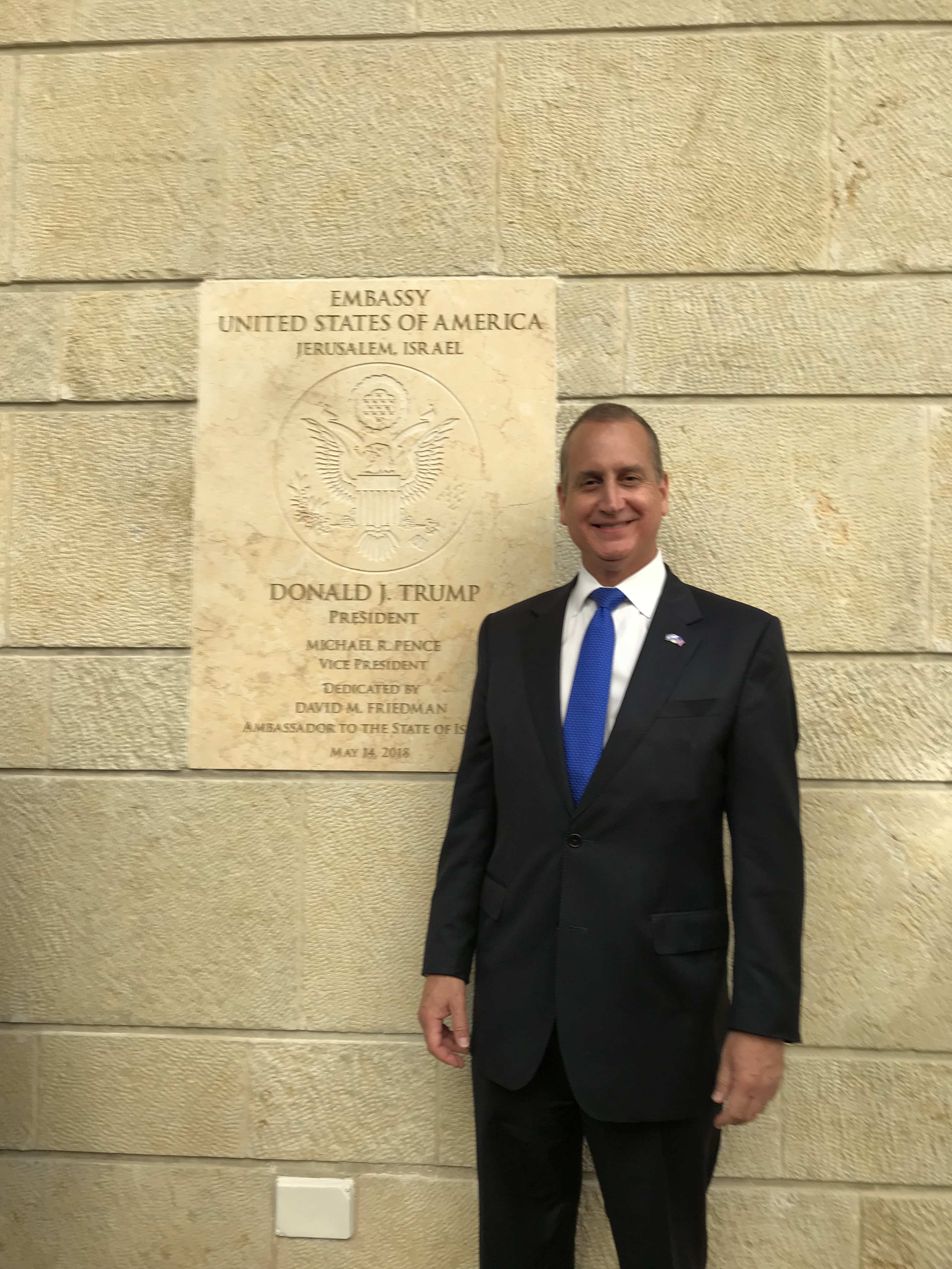 Congressman Diaz-Balart posing in front of US Embassy sign in Jerusalem