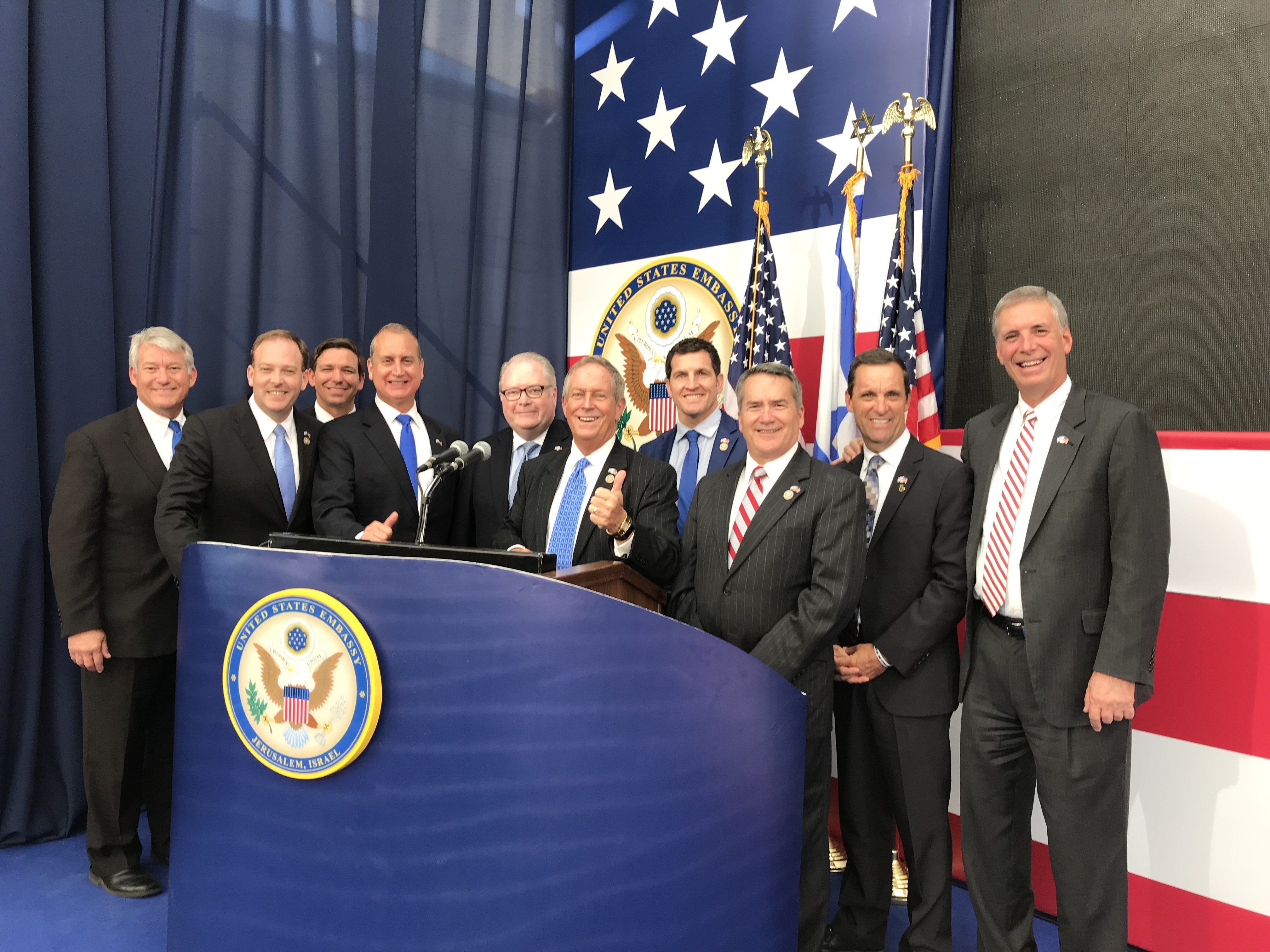 Congressman Diaz-Balart posing with others on stage