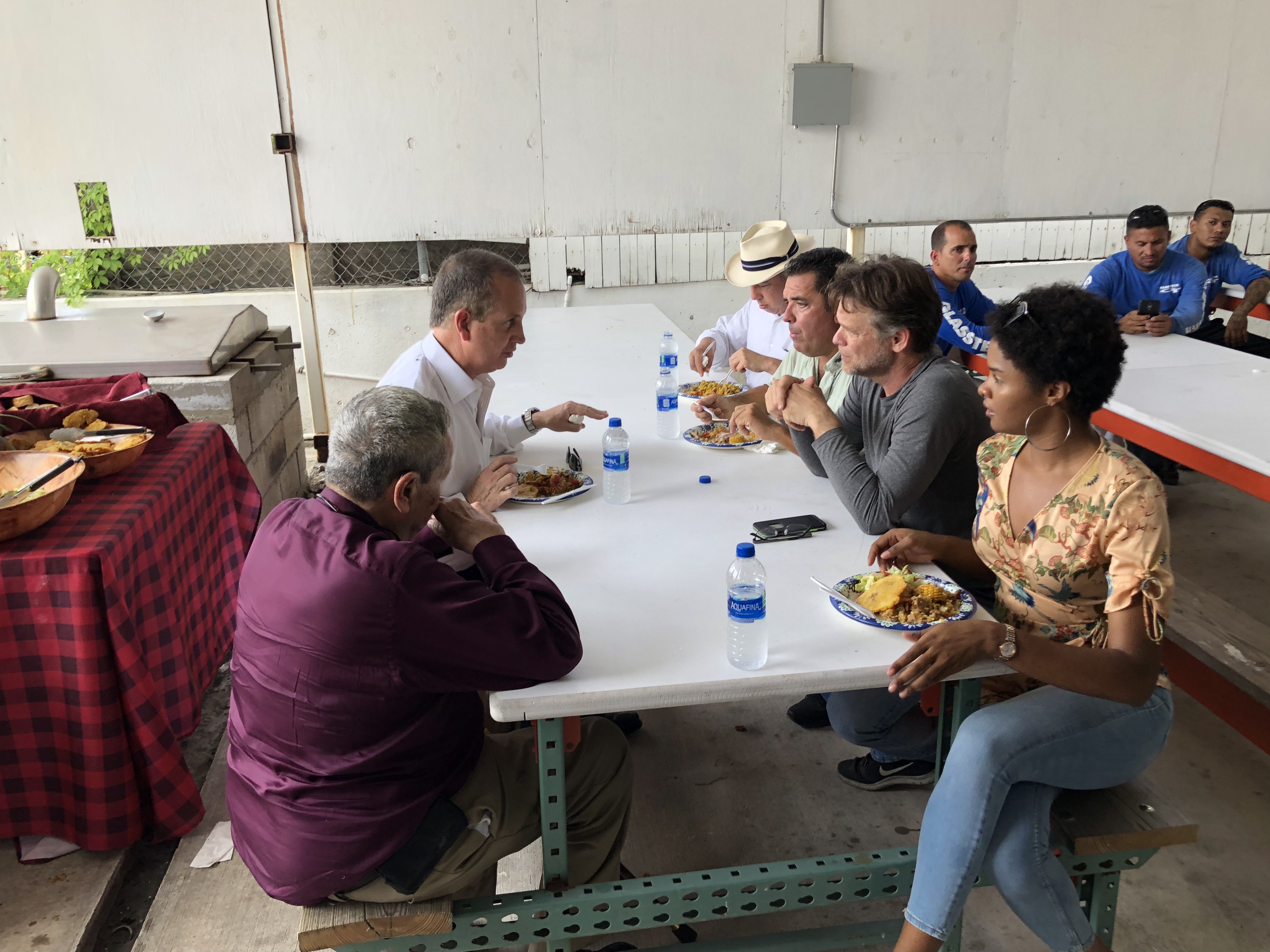 Congressman Diaz-Balart talking to people at lunch table