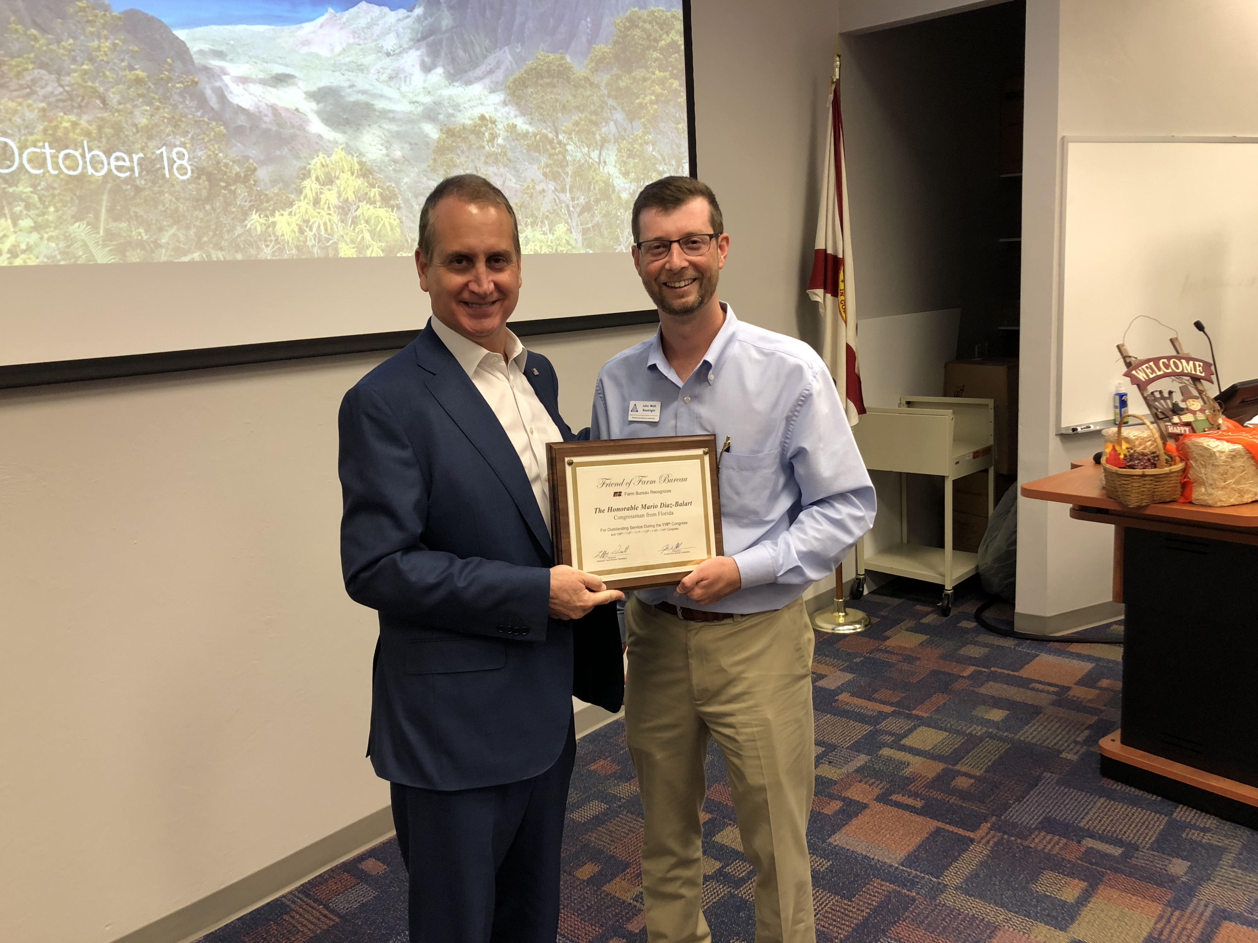 Congressman Diaz-Balart posing with awardee