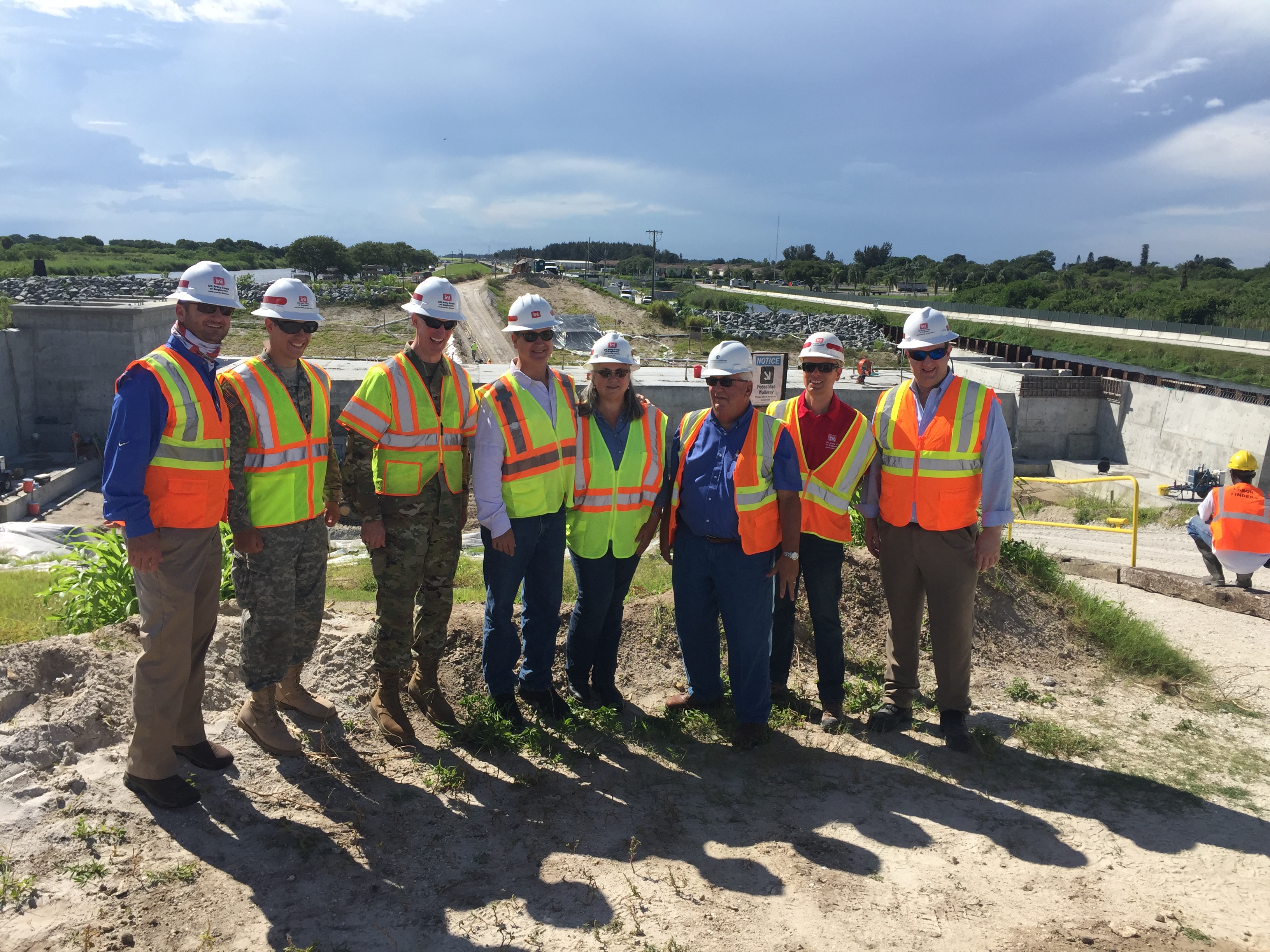 Congressman Diaz-Balart posing with others in the field