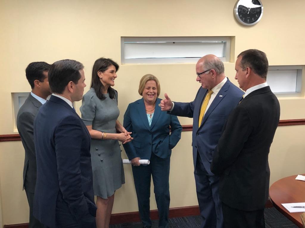 Congressman Diaz-Balart talking to people in a room
